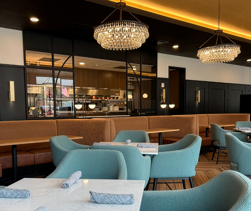 a restaurant with a chandelier and tables