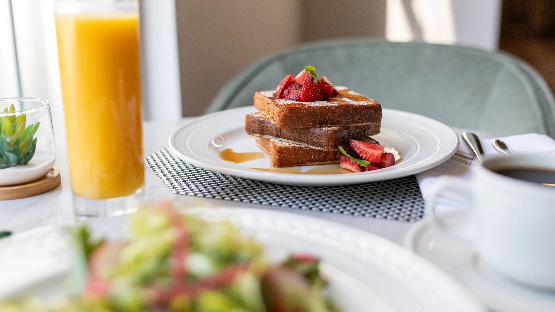 a stack of french toast with strawberries on a plate