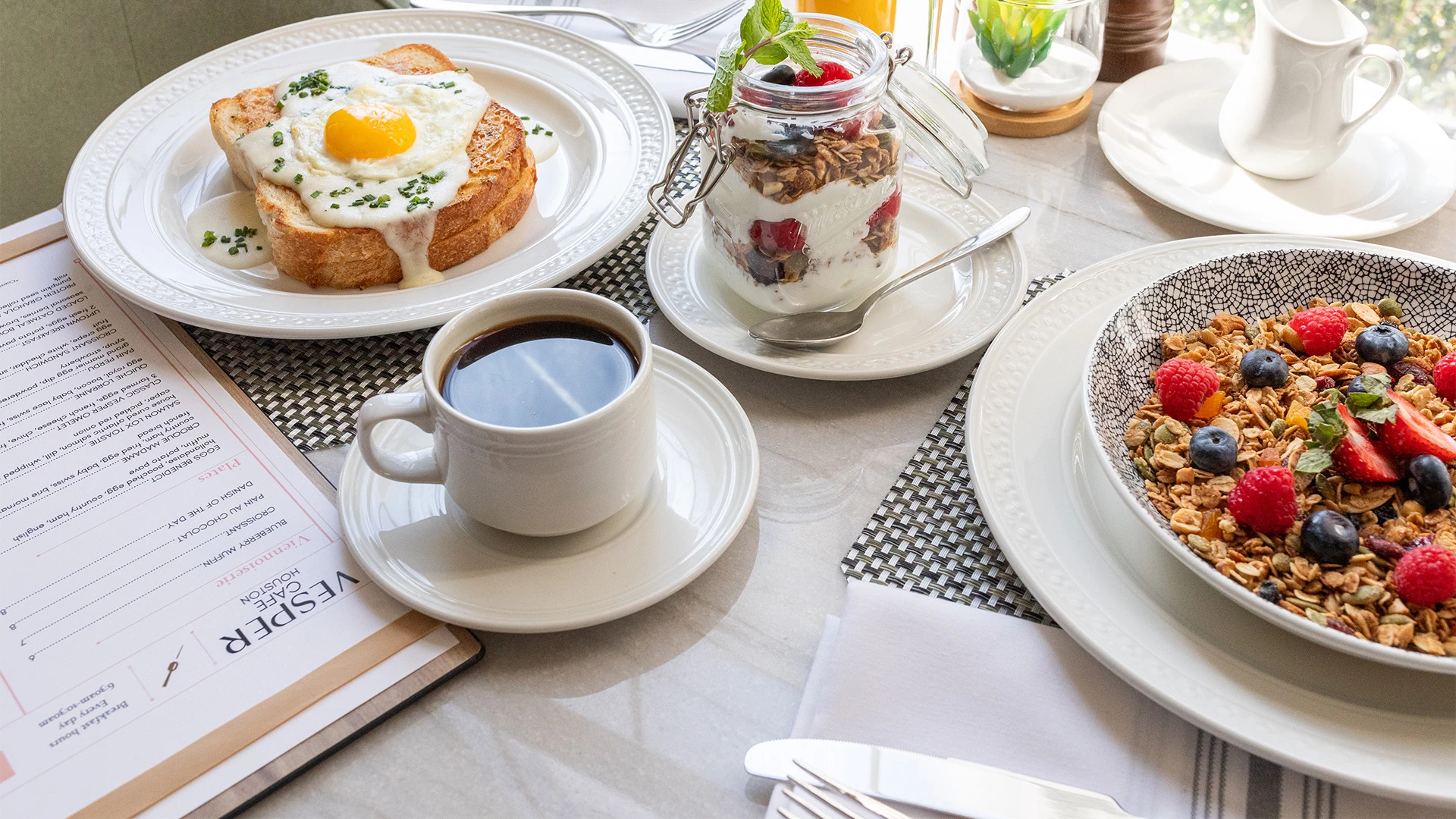a table with plates of food and a cup of coffee
