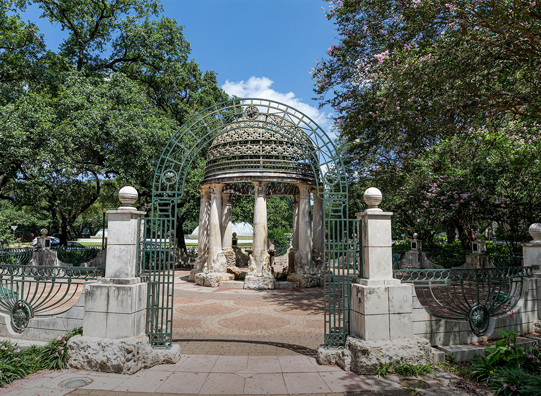 a stone gazebo with a dome and columns