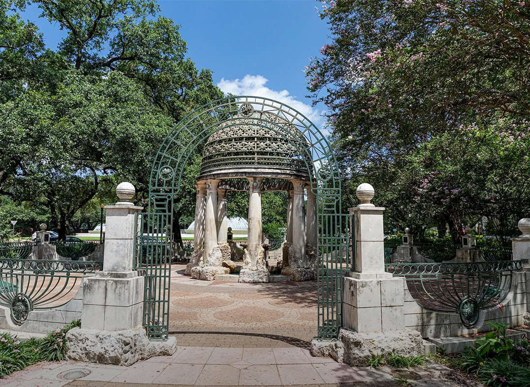 a stone gazebo with a dome and columns