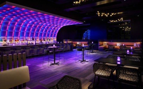 a room with tables and chairs and a bar