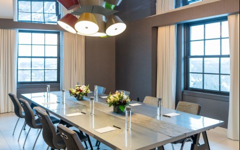 a table with chairs and flowers on it