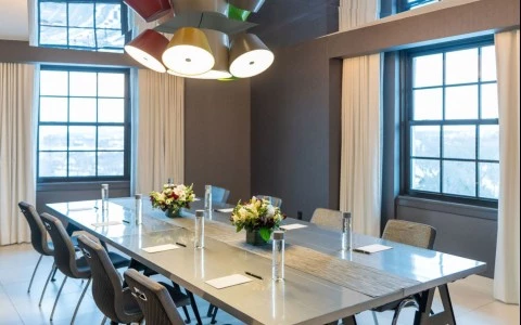 a table with chairs and flowers on it