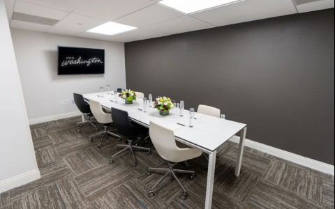 a room with a long table and chairs