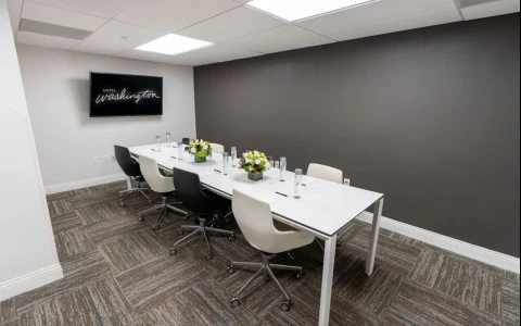 a room with a long table and chairs