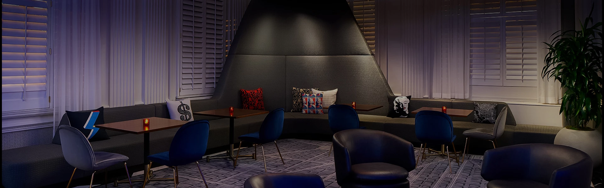 a room with blue chairs and a table