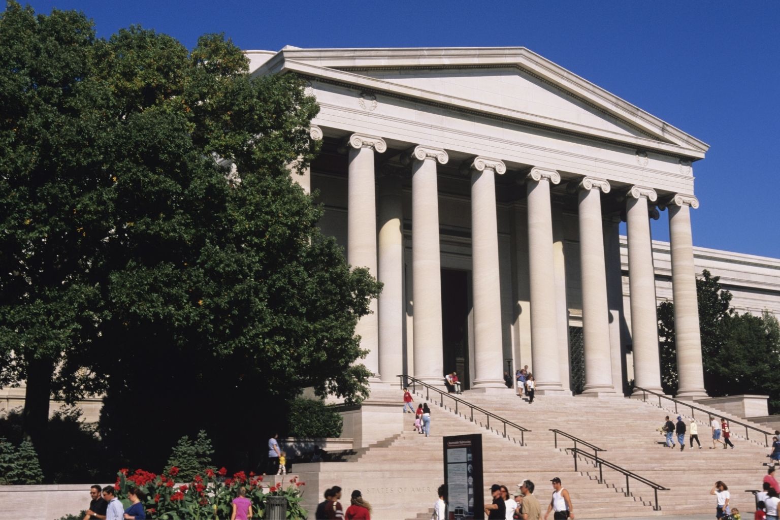 a group of people walking up stairs to National Gallery of Art