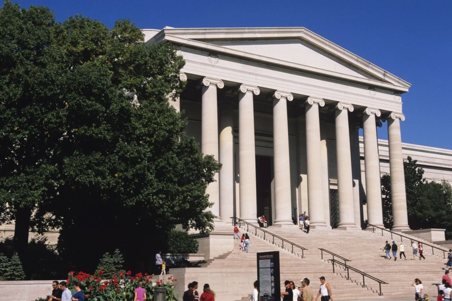a group of people walking up stairs to National Gallery of Art