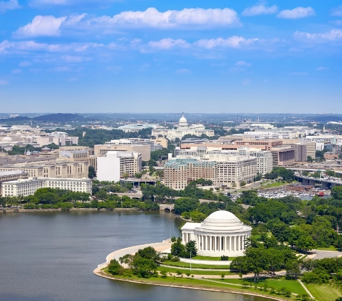 a white building with a domed roof and a body of water