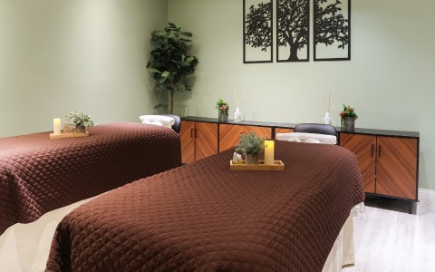 a massage room with two beds