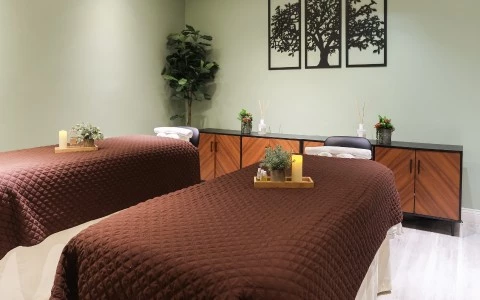 a massage room with two beds