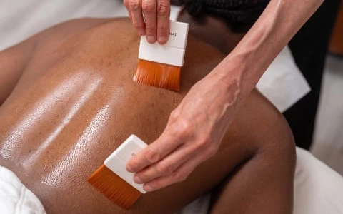 a person using brushes to remove skin