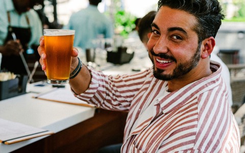 a man holding a glass of beer