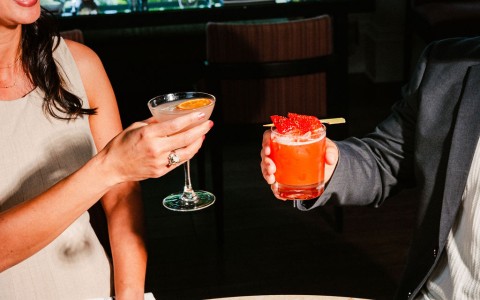 a man and woman holding drinks