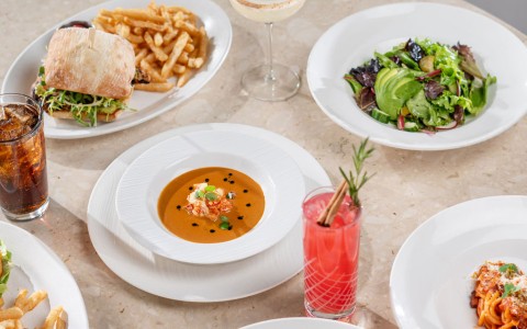 a table with plates of food and drinks