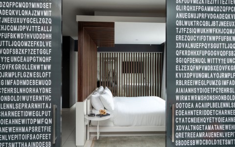 a bed with white sheets and a table with a coffee table