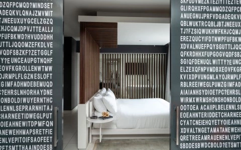 a bed with white sheets and a table with a coffee table