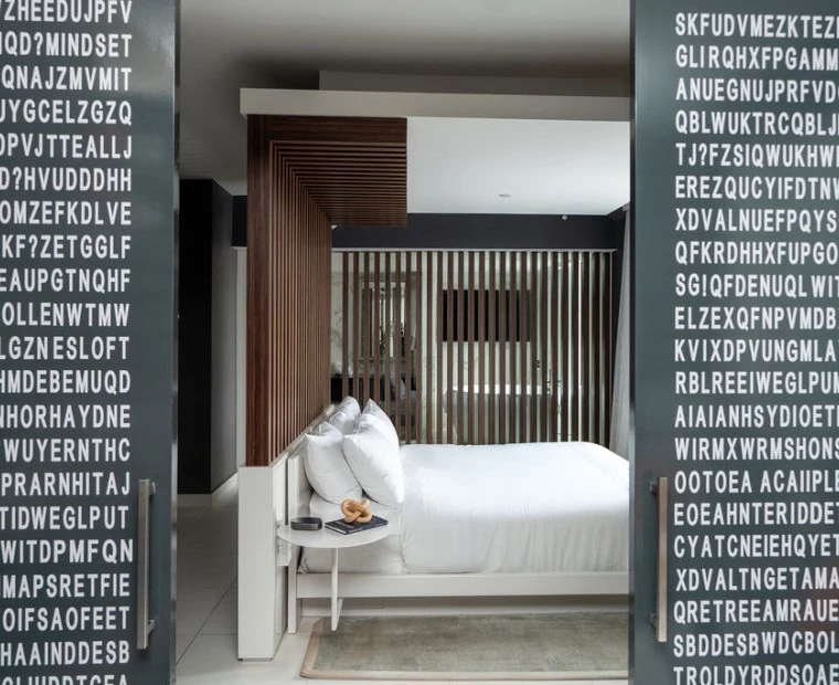 a bed with white sheets and a table with a coffee table