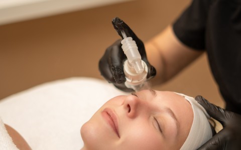 a woman getting a facial treatment