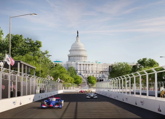 a race cars on a road with a white building in the background preview