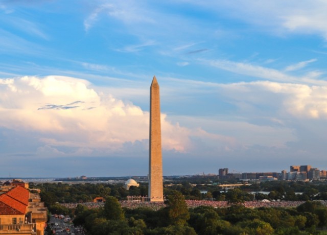 a tall monument with a crowd of people in the background preview