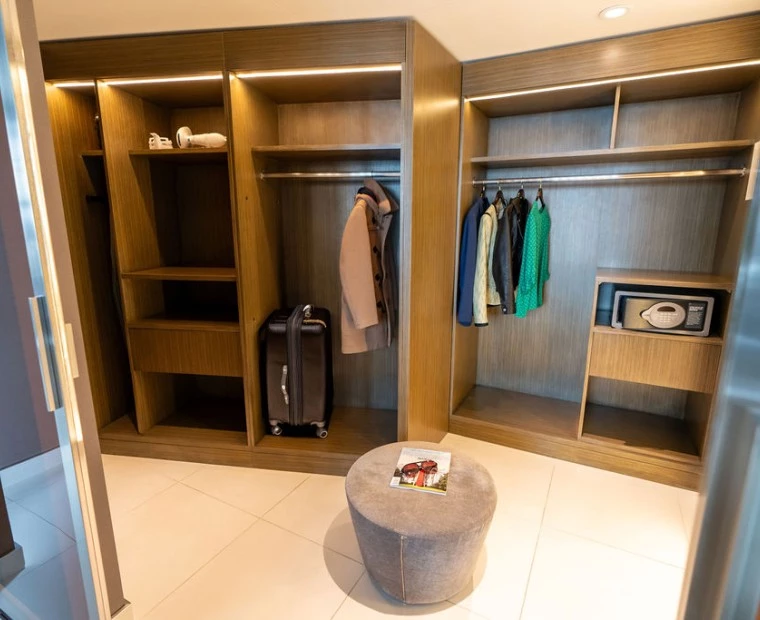 a large closet with a round ottoman