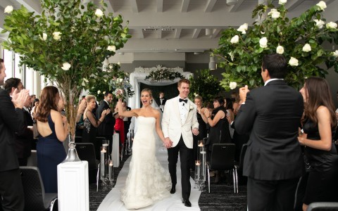 a man and woman walking down a aisle