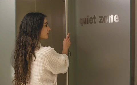 a woman in a robe looking at a sign