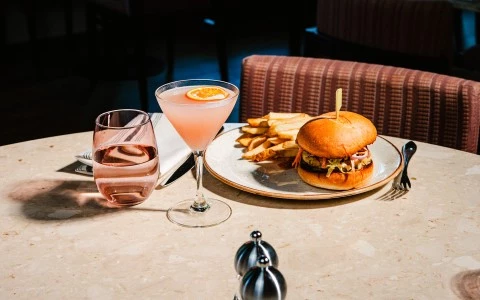 a plate of burger fries and a drink on a table
