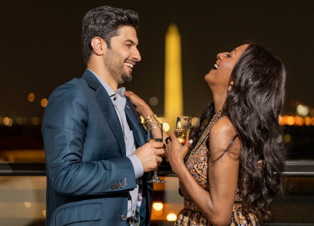 a man and woman holding wine glasses preview
