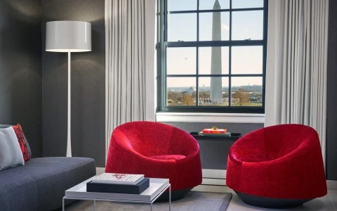 a room with red chairs and a large window