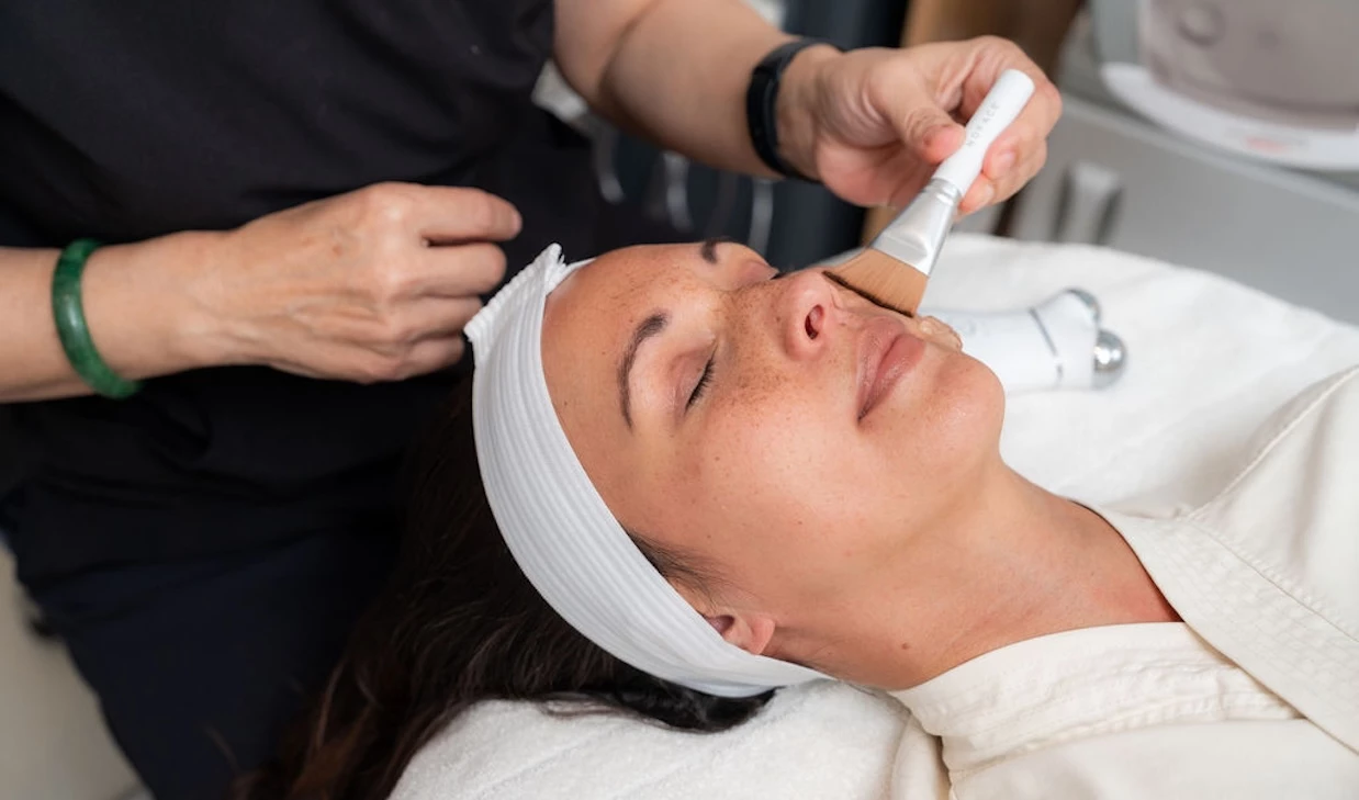 a woman getting a face mask