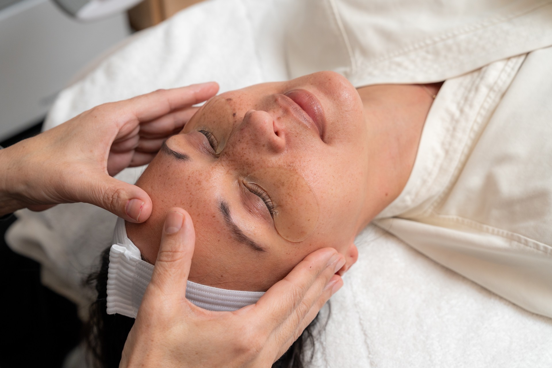 a woman receiving a face massage