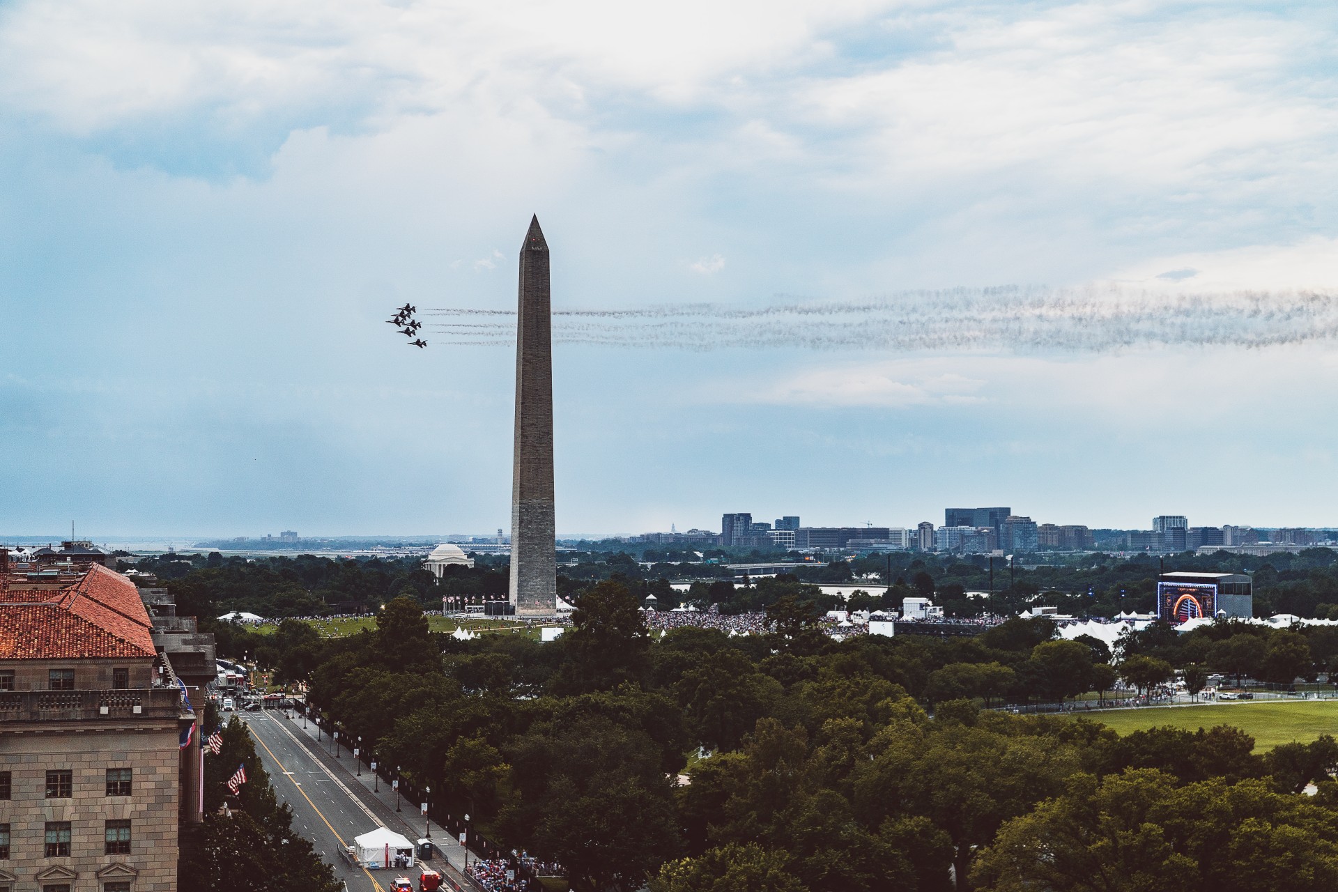 a monument with planes flying in the sky
