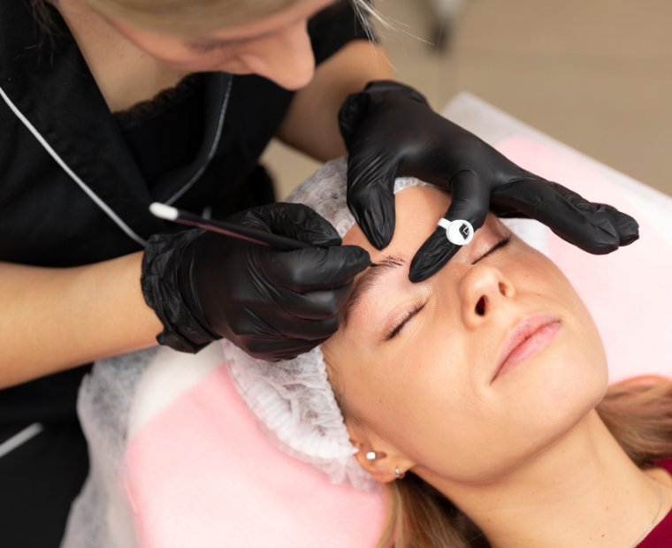 a woman getting eyebrow correction done