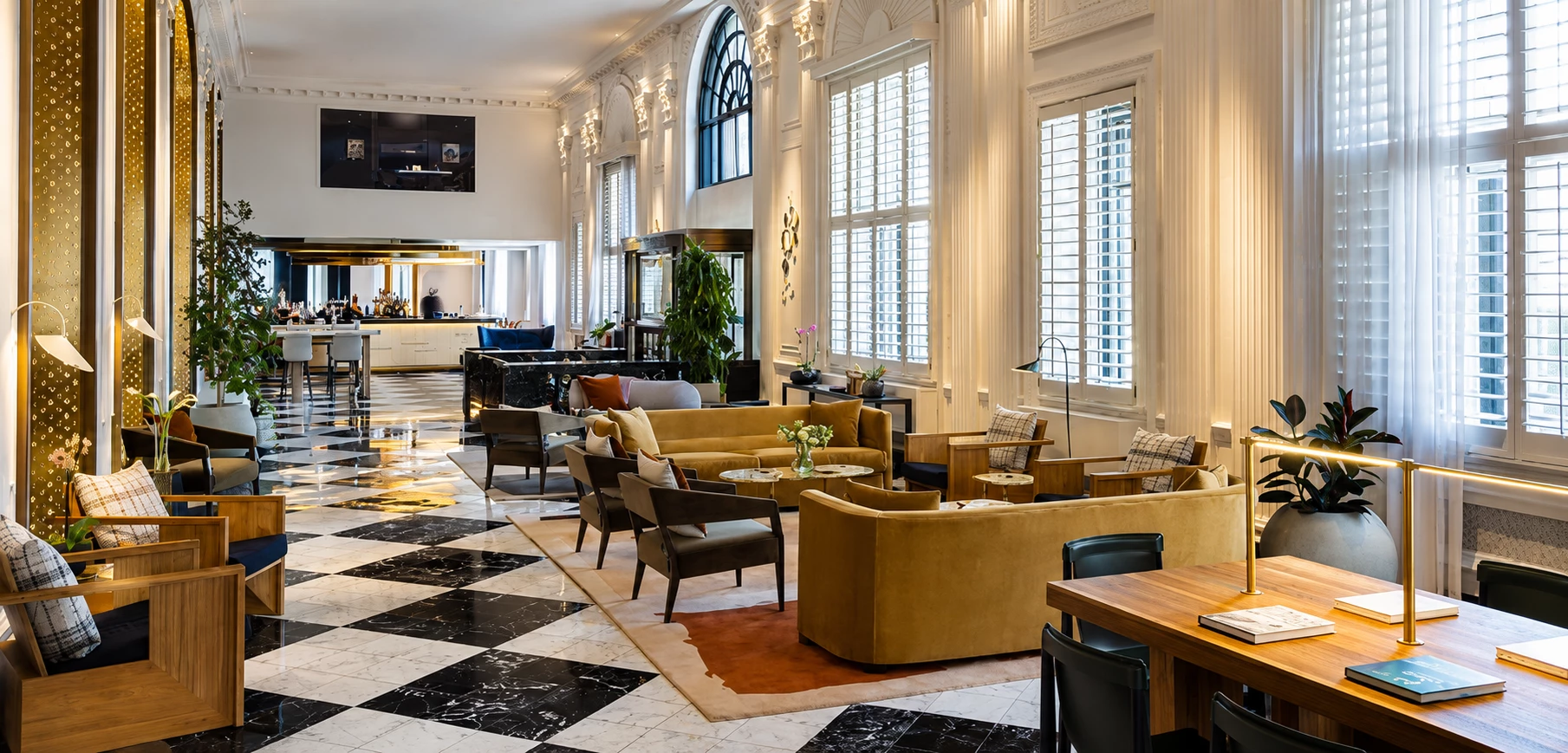 a room with a black and white checkered floor and large windows
