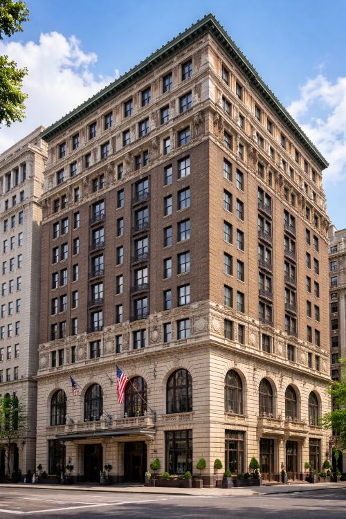 Italian Renaissance Revival facade of Hotel Washington featuring rusticated stone veneer, dark brick upper stories, and decorative sgraffito panels designed by Carrère and Hastings in Washington DC