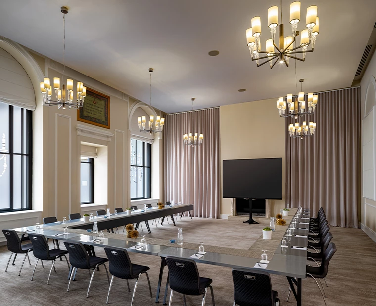 a large conference room with a large table, chairs, and a television