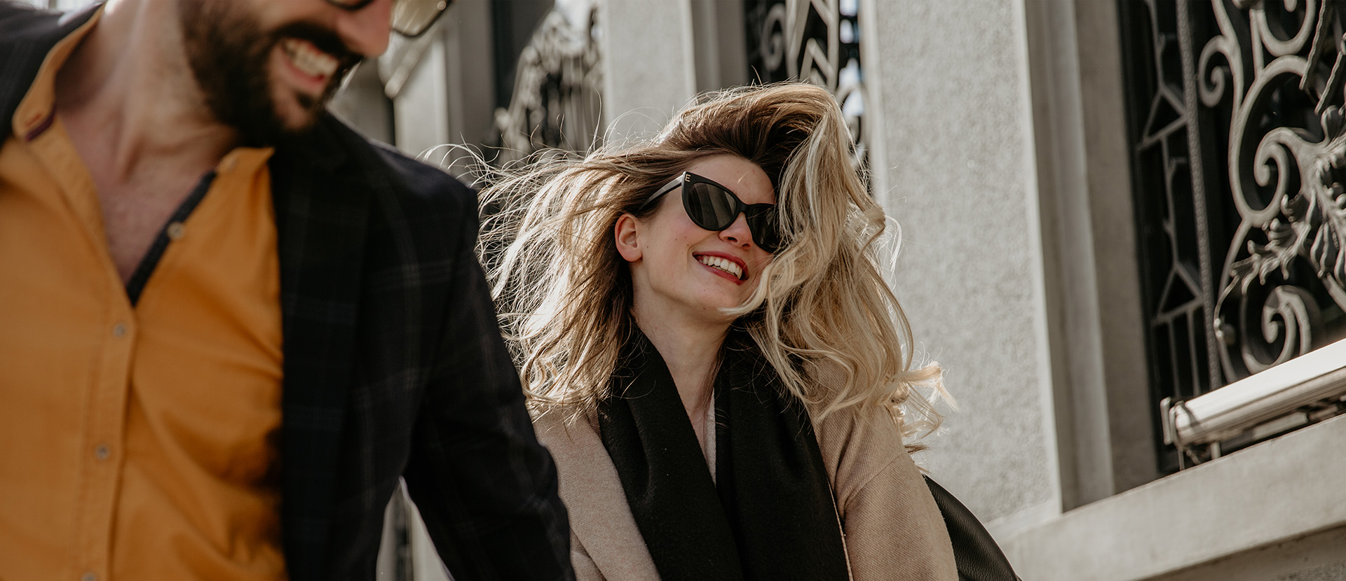 Woman walking in the city with the wind blowing in her blonde hair
