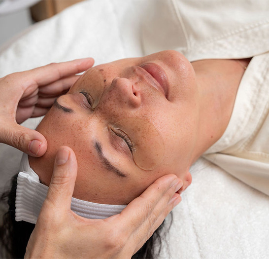 a woman receiving a face massage