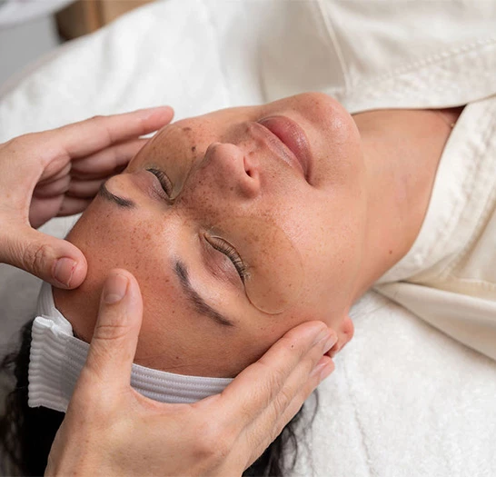 a woman receiving a face massage