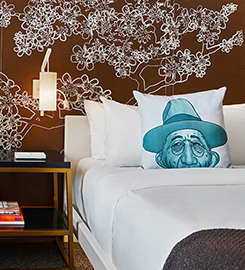 Modern guest room at Hotel Washington near the White House featuring a plush king bed, contemporary bedside table, and artistic wall mural in a luxury Washington DC hotel