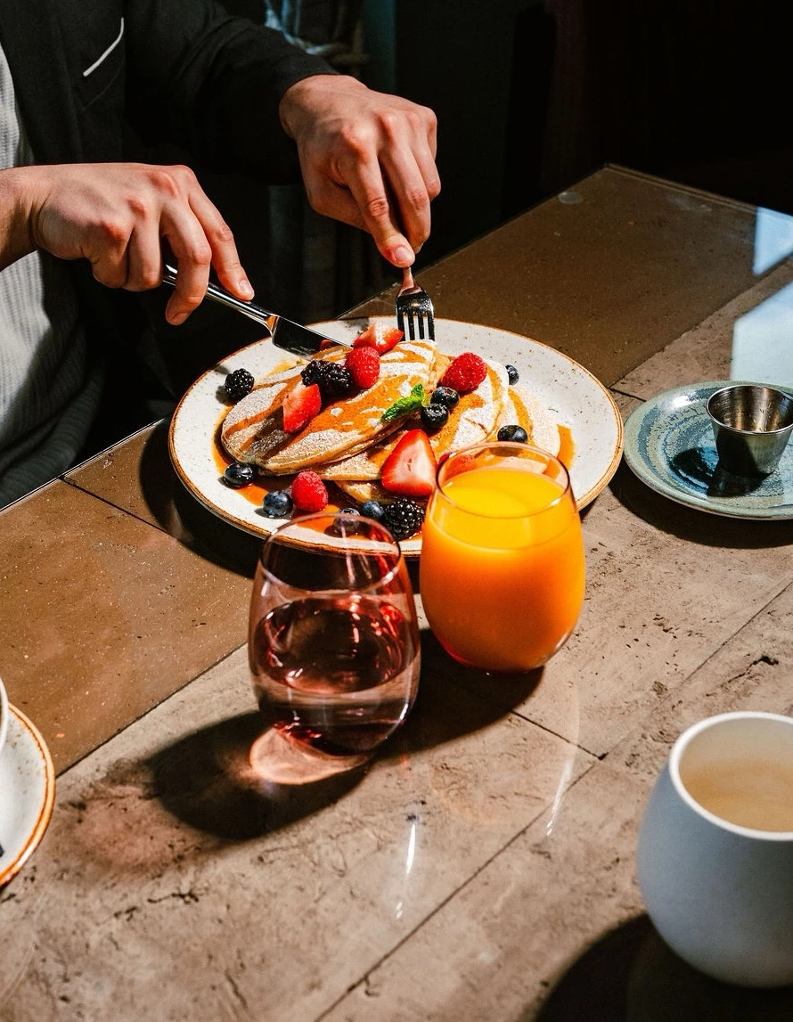 a person eating food on a plate