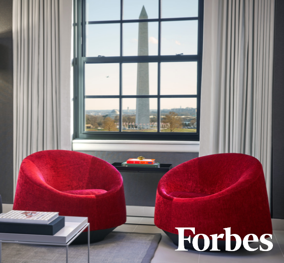 a room with red chairs and a window