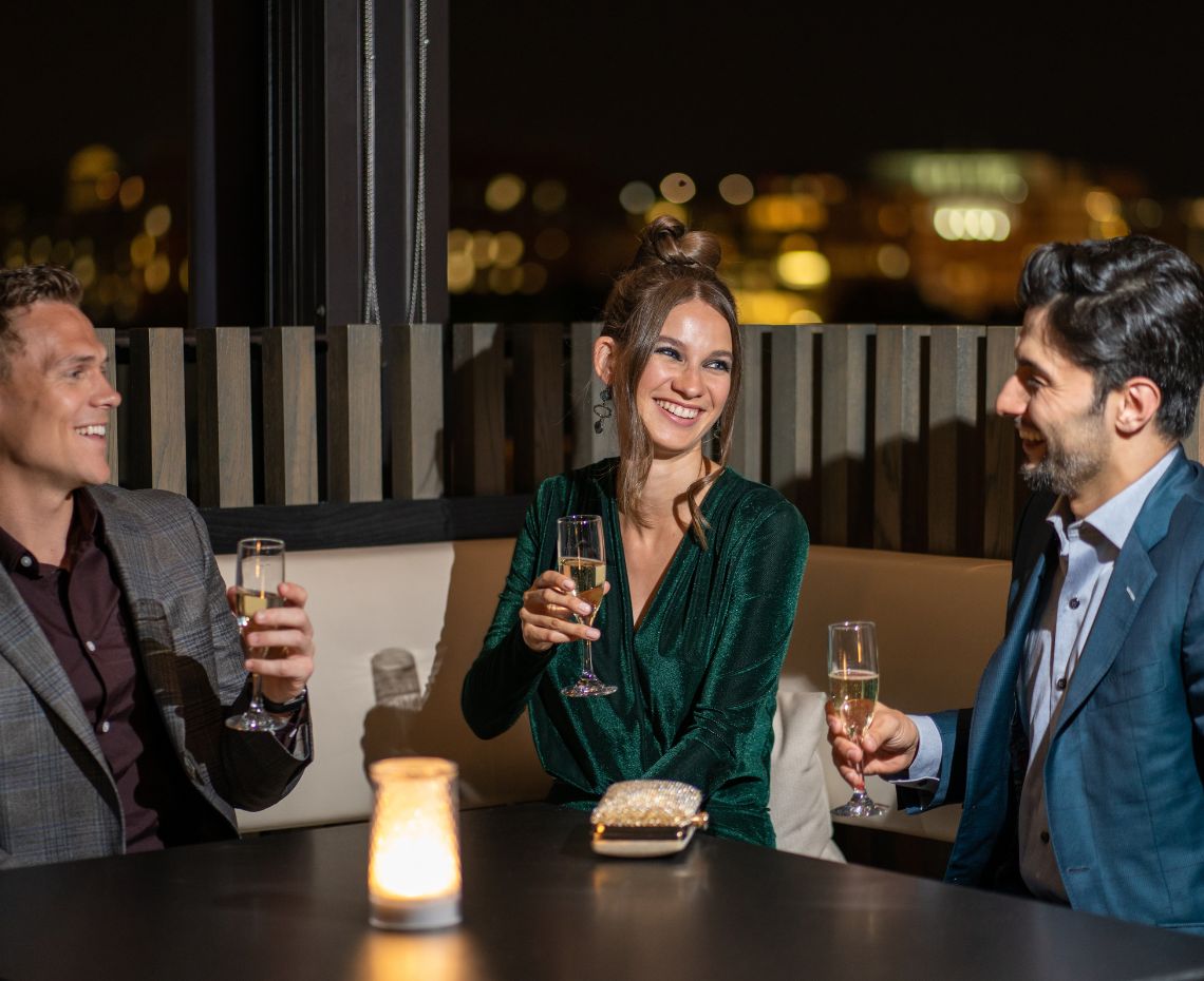a group of people sitting at a table with drinks