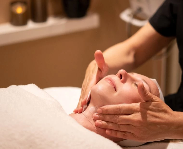a woman receiving a face massage