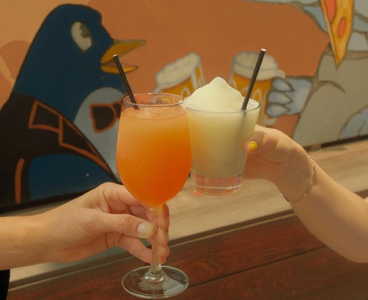 a pair of hands holding drinks