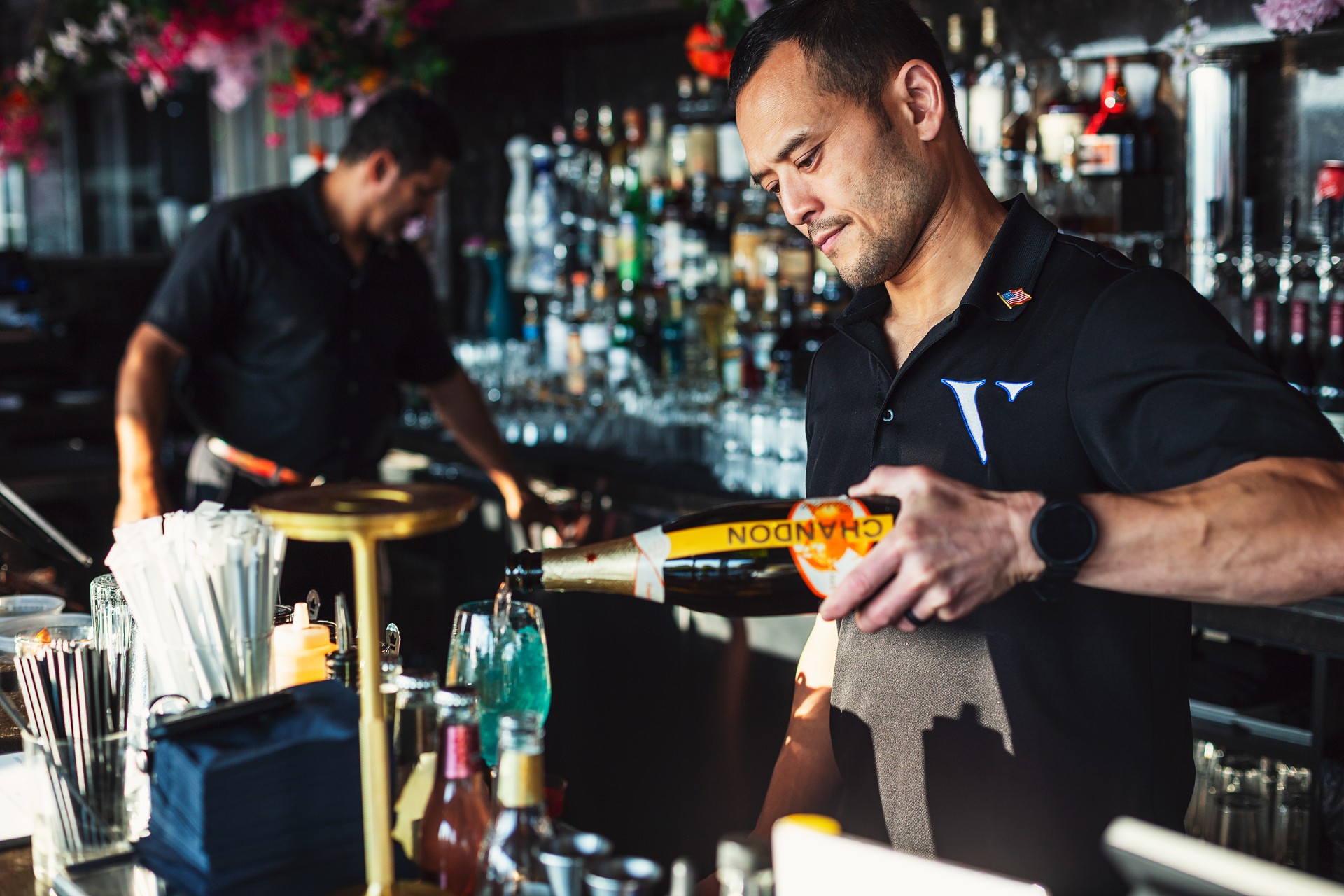 a man pouring a drink into a bottle