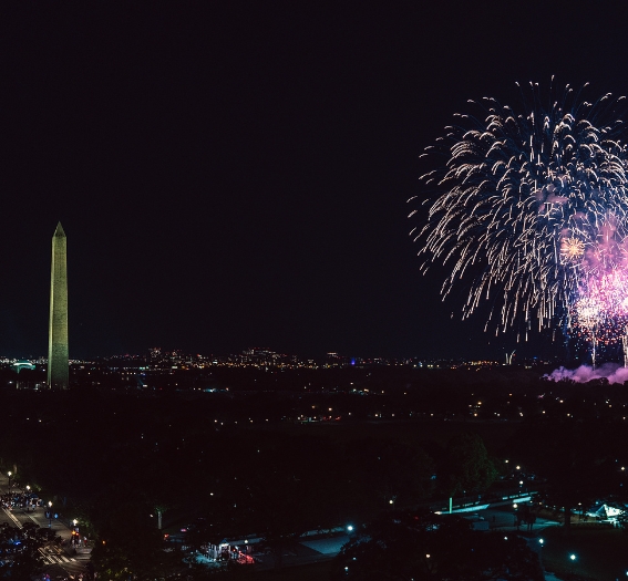 fireworks in the sky over a monument